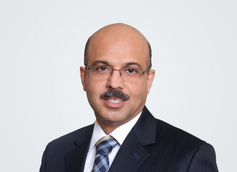 Headshot of Lakshya Sobti, a person with short dark hair, wearing a suit with a blue plaid tie.