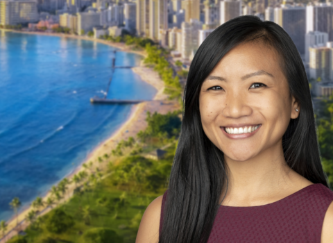 Headshot of Alicia Suzuki, a young woman with dark hair and a bright smile against the backdrop of Hawai'i